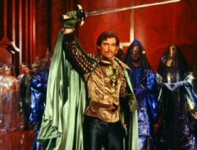 Timothy Dalton with a cape and sword